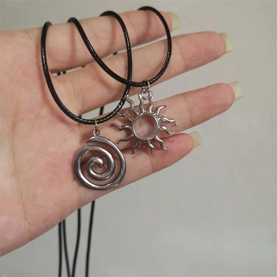 Silver Tone Spiral and Sunburst Pendant Necklaces on Black Cord